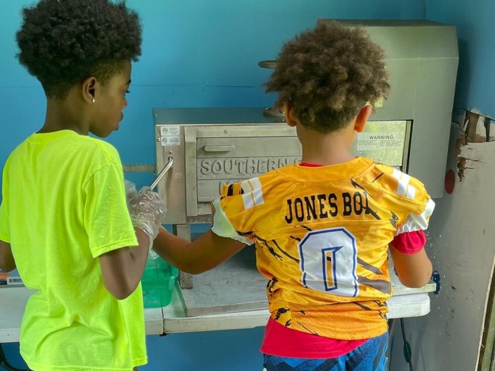 Dreyton (left) and his friend working in the stand.