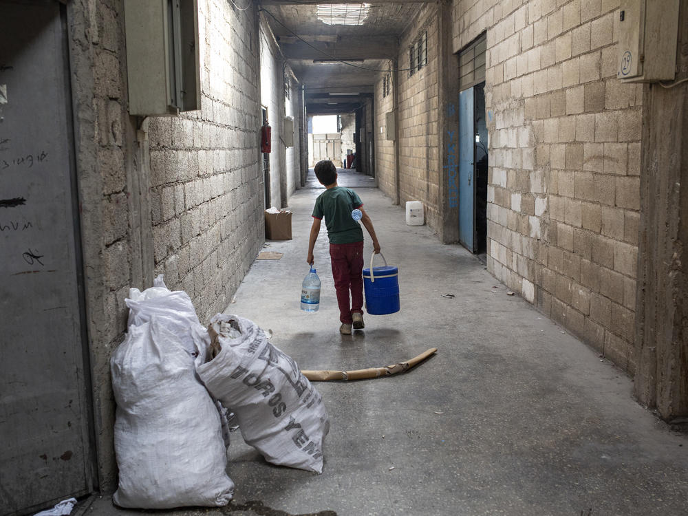 A child fetches water at a textile factory in Gaziantep, Turkey. Many children who work at this factory are migrants who escaped Syria with their families. They typically work 8 to 12 hour shifts, 6 or 7 days a week for just $15 a day. In 2021, 28 million people were estimated to be working under forced labor conditions — an eighth of them children.