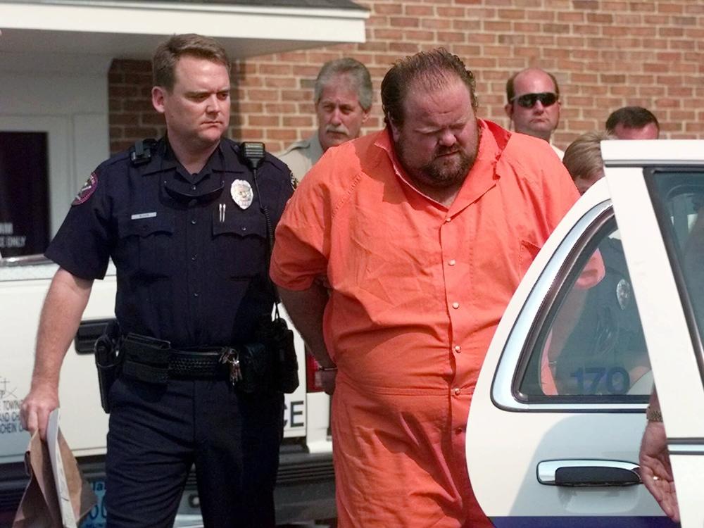 Officials escort murder suspect Alan Eugene Miller away from the Pelham City Jail in Ala., on Aug. 5, 1999. Miller, scheduled to be put to death by lethal injection on Sept. 22, 2022, for a workplace shooting rampage in 1999 that killed three men, says the state lost the paperwork he turned in selecting an alternate execution method.