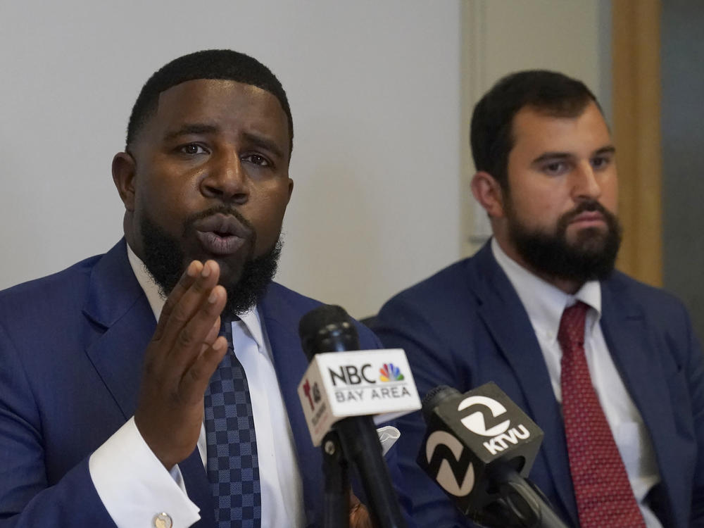 Attorneys Adanté Pointer (left) and Patrick Buelna, who represent a woman whose DNA from a sexual assault case was used by San Francisco police to arrest her in an unrelated crime, speak during a news conference announcing their lawsuit against the city on Monday.