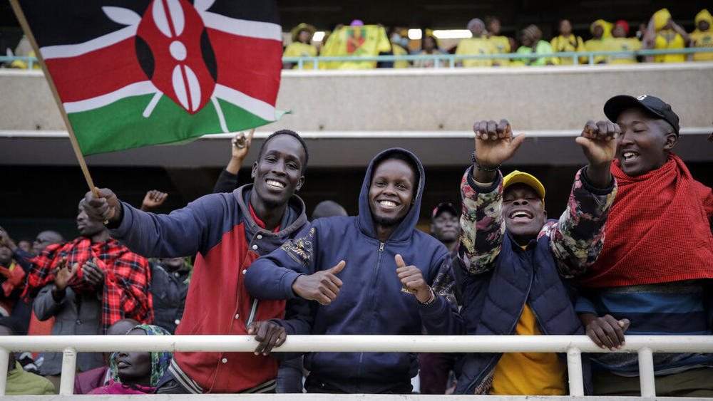 Supporters gather in the stands, one of them waving a national flag, as they await the inauguration of Kenya's new president William Ruto Tuesday at Kasarani stadium in Nairobi. A number of people were crushed and injured as Kenyans forced their way into the stadium.