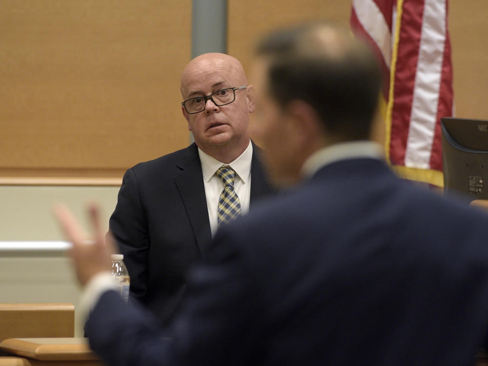 FBI agent William Aldenberg listens to lead plaintiff attorney Chris Mattei ask a question as he testifies Tuesday during conspiracy theorist Alex Jones' trial in Waterbury, Conn.