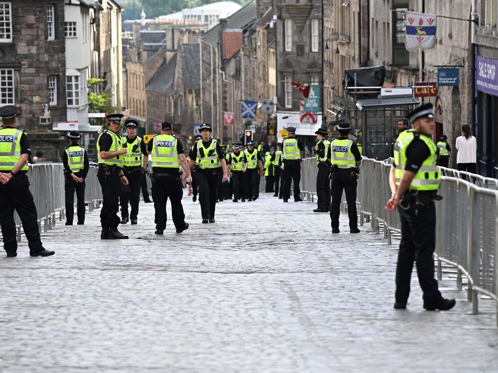 Police officers patrol in the streets of Edinburgh on Sept. 11, 2022, as preparations are made for the arrival of the coffin of Queen Elizabeth II.