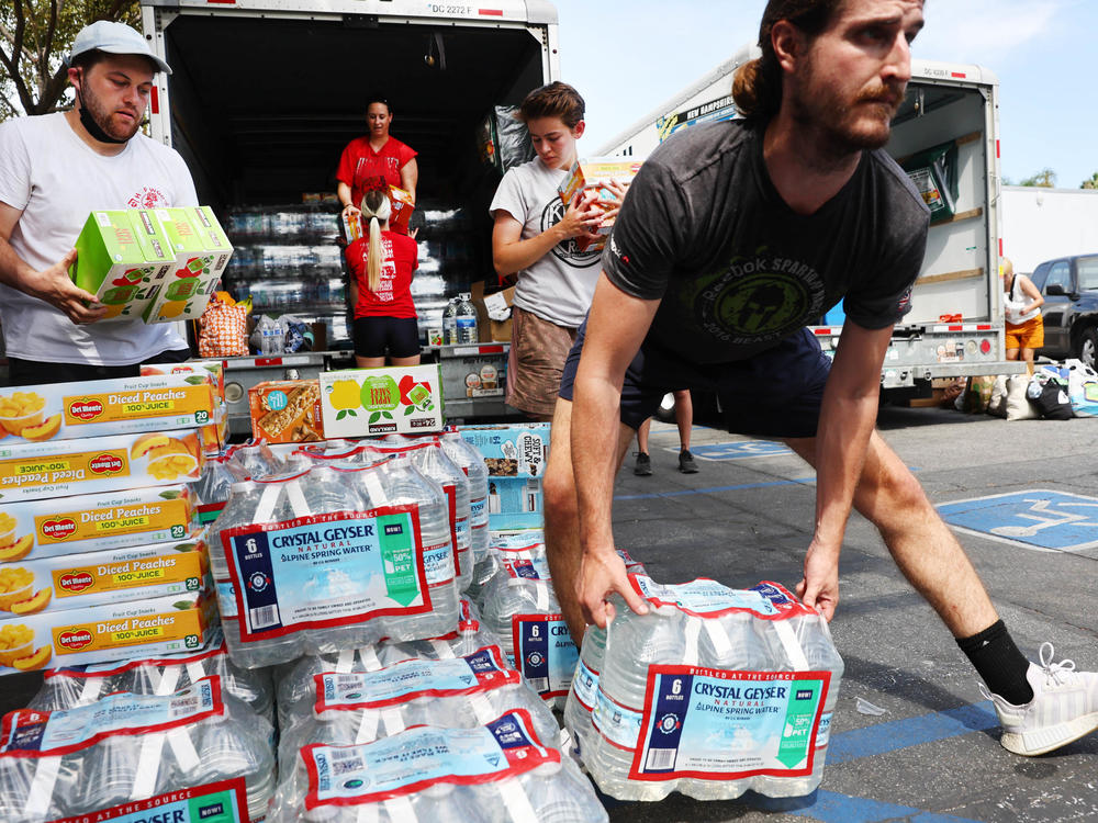 Volunteers deliver water and other items to the homeless in Los Angeles. Poverty rates dropped in 2021 thanks in part to pandemic policy measures, but poverty advocates fear they will rise again without those measures in place.