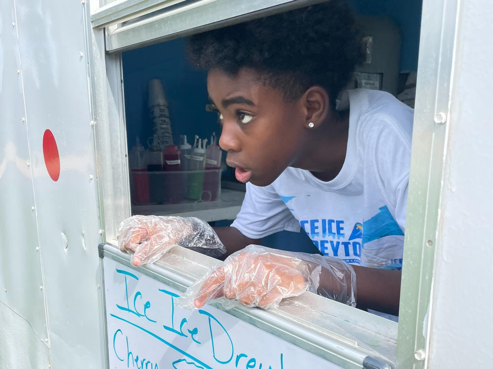 Dreyton McDonald sells snow cones from his mobile shop, Ice Ice Dreyton, in Ocala, Fla.
