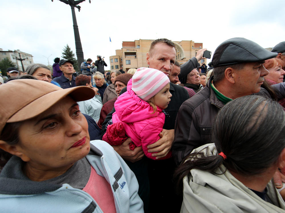 Local residents gather on Tuesday to receive humanitarian aid in Balakliia, a town recently liberated by the Ukrainian military as part of its counteroffensive in the Kharkiv region.
