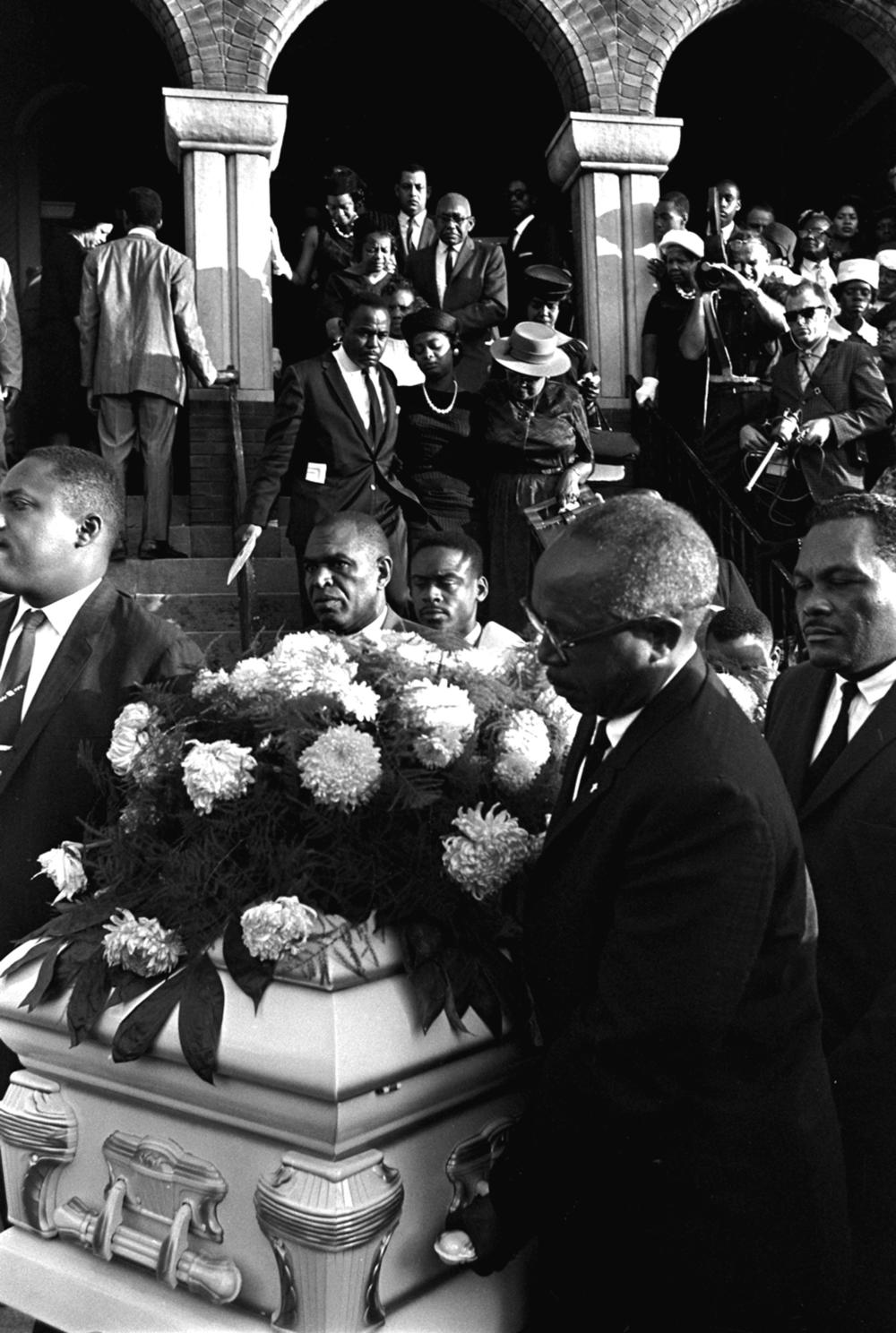 Christopher McNair (center left), and Maxine McNair (right) parents of Denise McNair, follow her coffin during her funeral in Birmingham, Ala., in 1963.