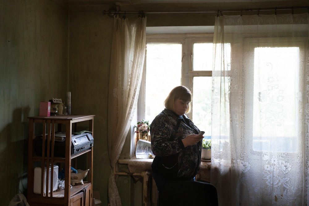 Domoratska responds to phone messages for a client, Anna, to let relatives know that she's OK.