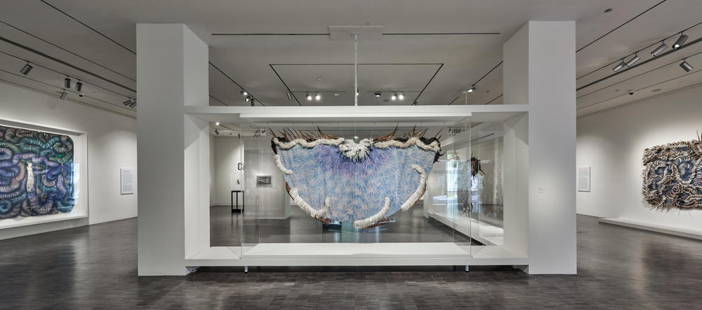 One of Carlos Villa's feathered capes, on view in the exhibition.