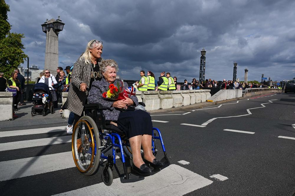 Women leave the Westminster Palace after paying their respects to the late queen on Thursday.