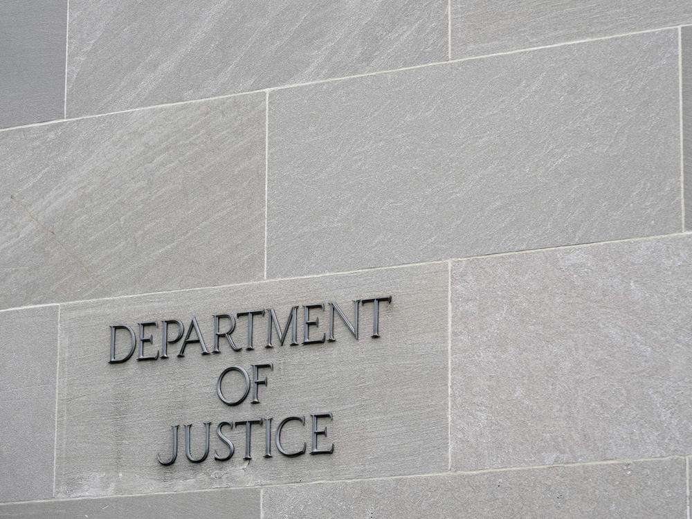 A sign marks the facade of the Department of Justice building in Washington on May 5, 2022.