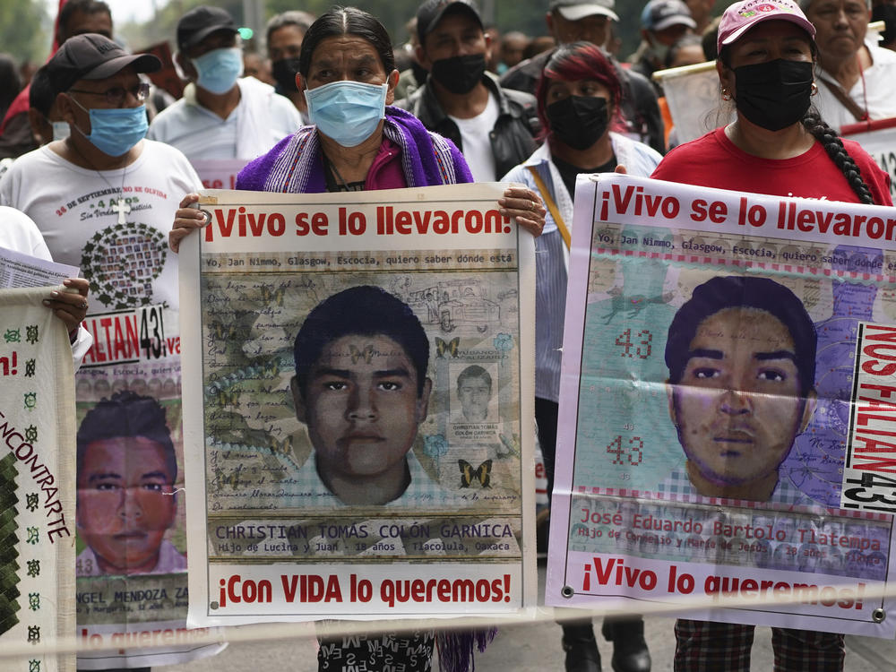 Family members and friends march seeking justice for the missing 43 Ayotzinapa students in Mexico City, Aug. 26, 2022.