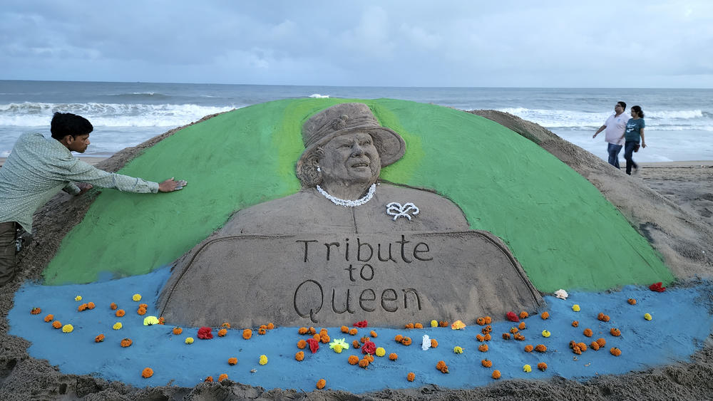 Artist Manas Sahoo creates a sand art tribute to Queen Elizabeth on a beach in Puri, India, on Sept. 9.