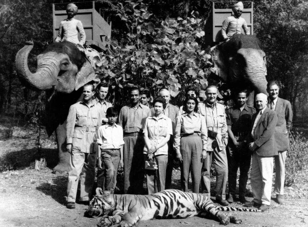 Britain's Queen Elizabeth II and Prince Philip stand with their hosts Maharajah and Maharanee of Jaipur, in the forests of Rajasthan, India, on Jan. 24, 1961. Prince Philip shot the tiger in the foreground.