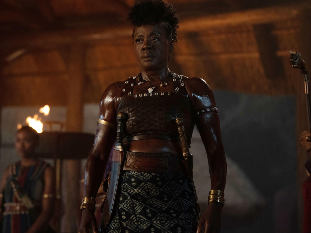 Nanisca (Viola Davis) wields a sword and hacks her way through the many men who get in her way in<em> The Woman King.</em>