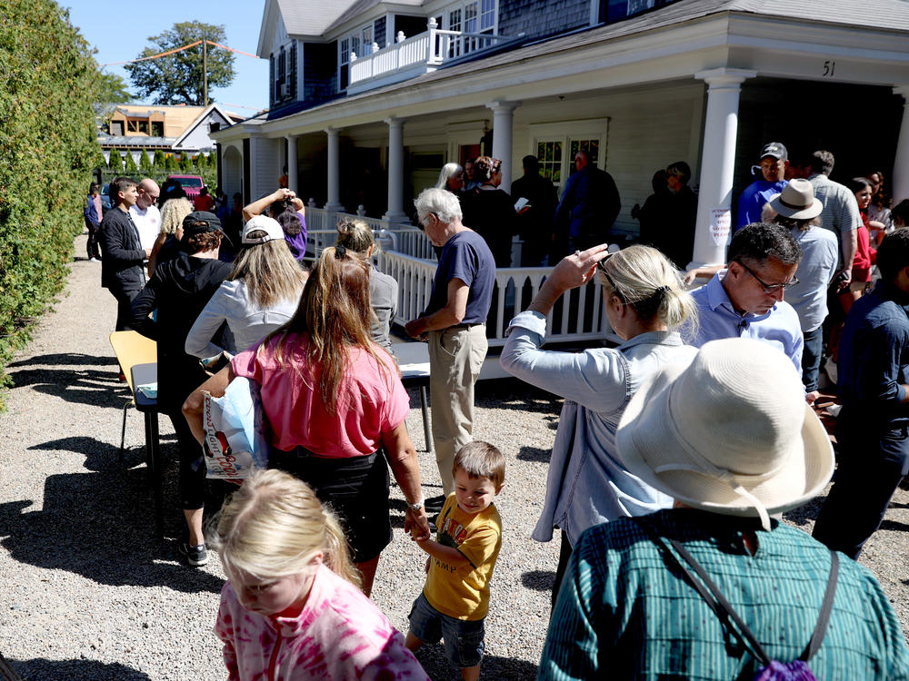 Marthas Vineyard residents line up in front of St. Andrews Parish House to donate food to the recently arrived migrants. Two planes of migrants from Venezuela arrived suddenly Wednesday night on Martha's Vineyard.