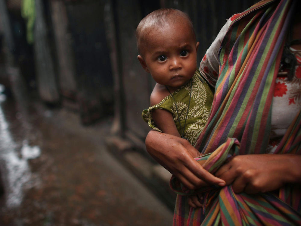 A women holds a child in the alley of a slum in Dhaka, Bangladesh. Bangladesh is one of the world's poorest countries; nearly 40% of the population survive on less than a dollar a day.