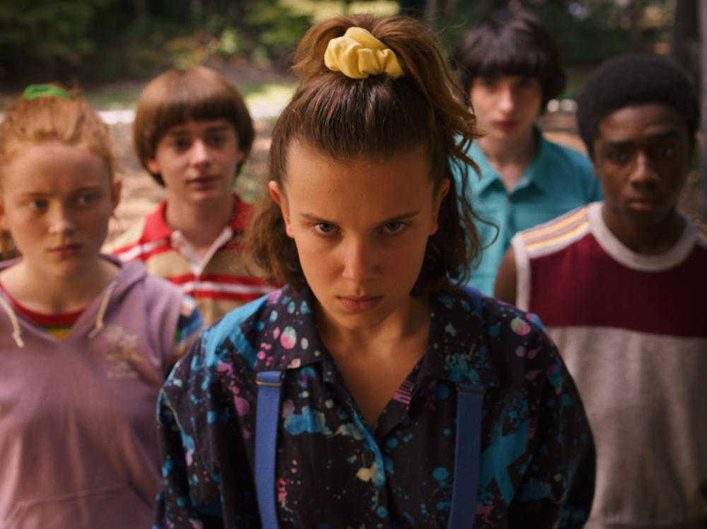 In the 2019 season of <em>Stranger Things</em>, Eleven (portrayed by Millie Bobby Brown<em>) </em>pulls a half-pony with a yellow scrunchie.