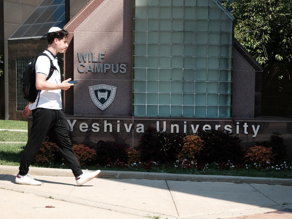 People walk by the campus of Yeshiva University in New York City on Aug. 30. The school told students in an email that it was pausing all student clubs on campus.