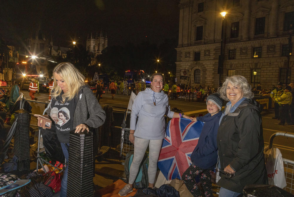 Michelle Larsen 42, poses for a picture with her child McKinley Larsen, 11, and mother Barbara Tuma, 67, where they are camping overnight outside of Westminster Hall and the houses of Parliament in London.
