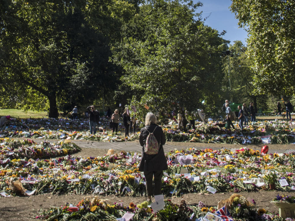 Mourners and members of the public lay flowers at the Queen's official floral tribute area in Green Park, London on Saturday.