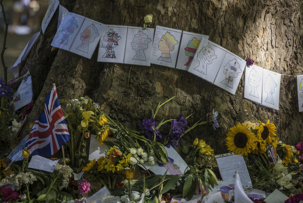 The park's trees became part of the tribute, as people hung balloons and flags from their branches and taped cards to their trunks.