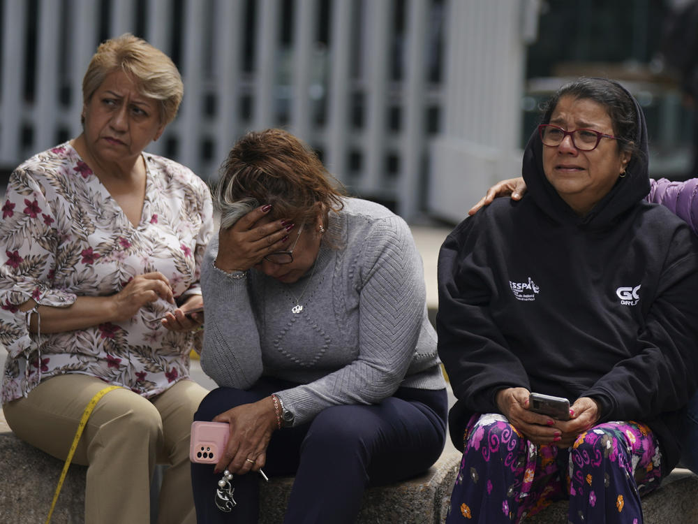 People gather outside after a magnitude 7.6 earthquake was felt in Mexico City on Monday, Sept. 19. The quake hit at 1:05 p.m. local time, according to the U.S. Geologic Survey, which said the quake was centered near the boundary of Colima and Michoacan states.