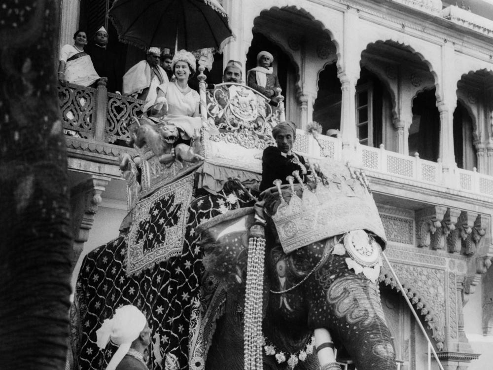 Queen Elizabeth II rides on an elephant during one of her three official visits to India. This photo is from February 1961.