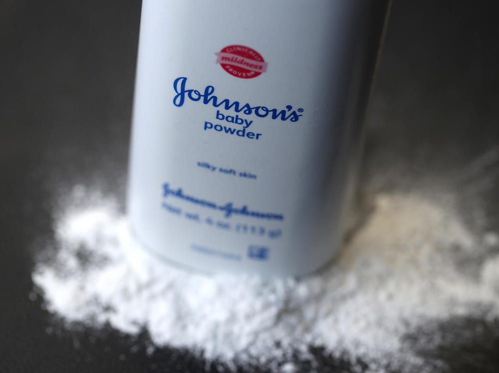 A bottle of Johnson & Johnson baby powder is displayed on a table. J&J pulled its iconic Johnson's baby powder off the shelves in the U.S. in 2020.