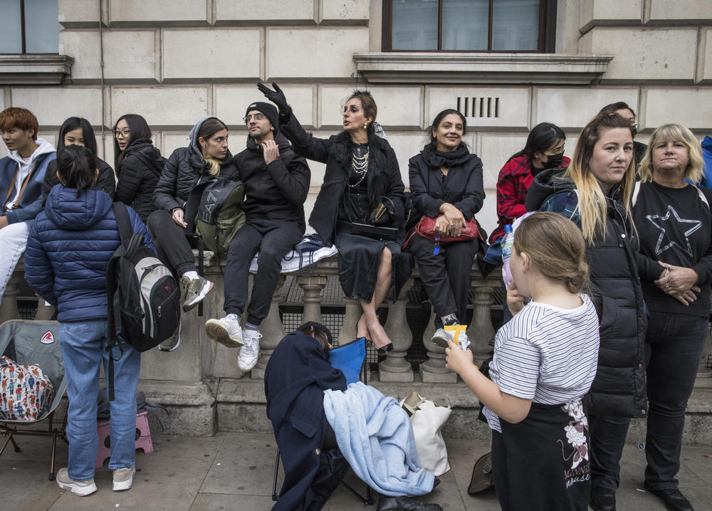 Mourners gather to say goodbye to Queen Elizabeth II outside of the Palace of Westminster and the houses of Parliament in London on Monday.