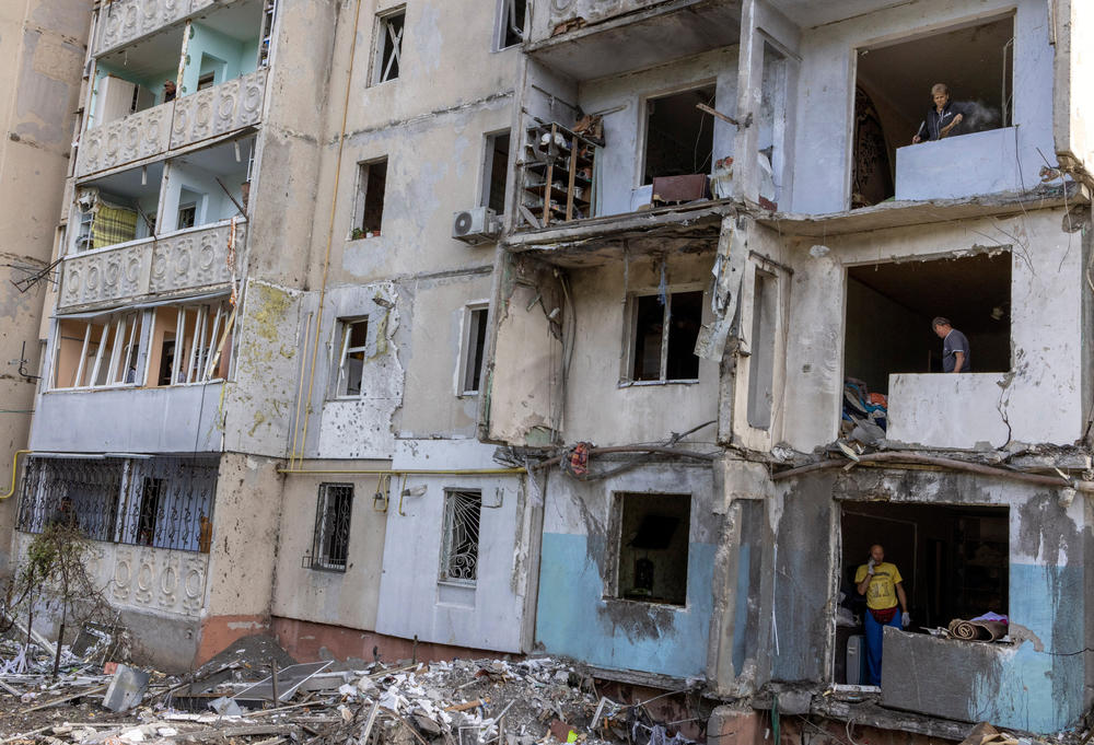 People inspect and clean their apartments in a residential building destroyed by a strike, amid Russia's invasion of Ukraine, in Mykolaiv on Sept. 14.