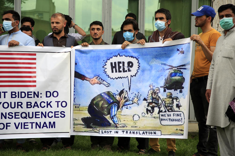 Former Afghan interpreters hold banners during a protest against the U.S. government and NATO in Kabul on April 30, 2021.