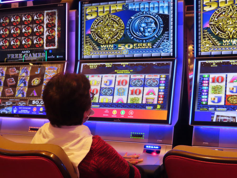 A gambler plays a slot machine at the Hard Rock casino in Atlantic City, N.J. on Aug. 8, 2022.