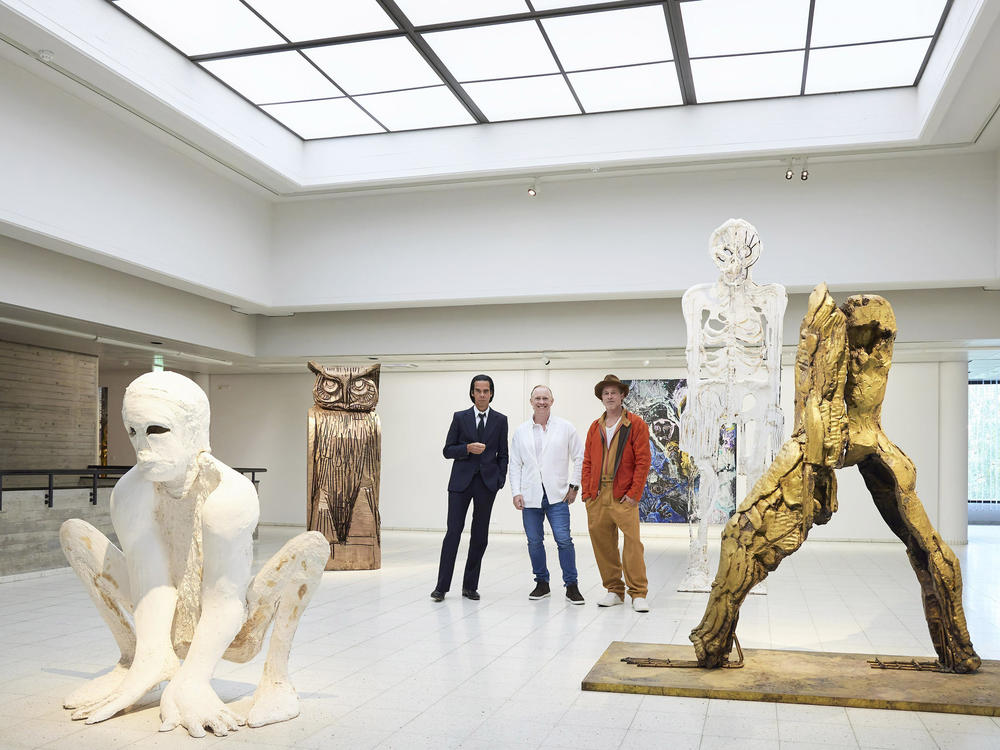 Musician Nick Cave (from left), artist Thomas Houseago and with actor Brad Pitt pose prior to the opening of their joint exhibition, in Tampere, Finland, on Saturday.