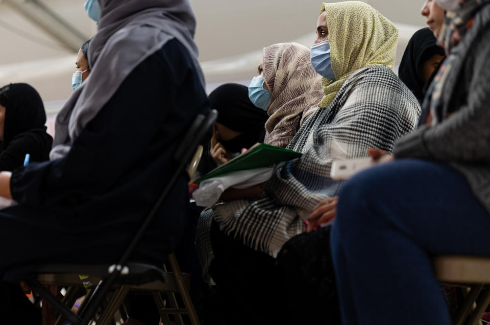 Afghan women listen to a lesson in an education center in a refugee camp at Holloman Air Force Base in New Mexico on Nov. 4, 2021. The Department of Defense and Department of Homeland Security's Operation Allies Welcome initiative aims to support and house Afghan refugees as they transition into more permanent housing in the U.S.