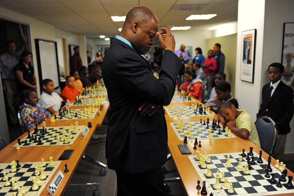 Grandmaster Maurice Ashley, seen here in a file photo from 2011 when he played 30 school-aged children in Washington, D.C., says reigning world champion Magnus Carlsen should clear the air over his recent matches with Hans Niemann.