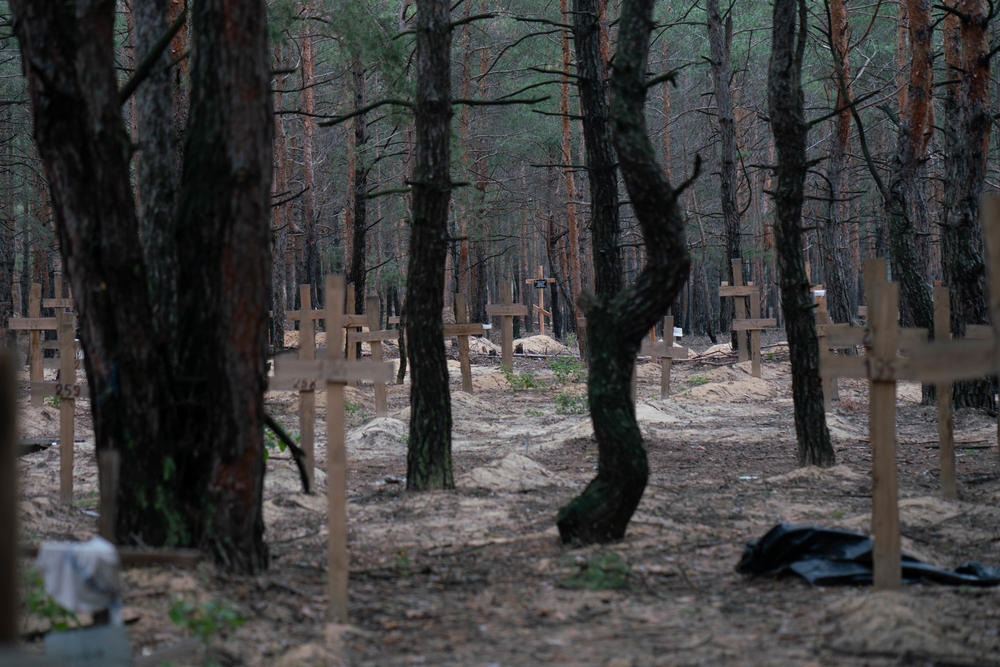 Scenes from a mass grave site in Izium on Friday.