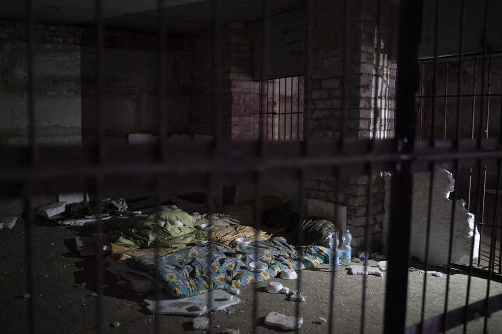 Bedding and sleeping bags in a basement where Ukrainian authorities say they found a torture cell used during the Russian occupation, in the retaken village of Kozacha Lopan on Saturday.
