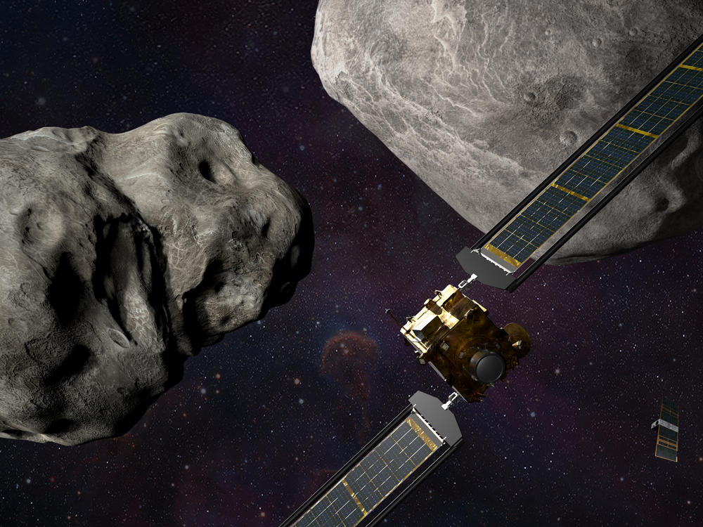 This illustration shows the DART spacecraft approaching the two asteroids, Didymos and Dimorphos, with a small observing spacecraft nearby.