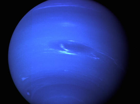 Neptune typically appears blue in photographs due to methane gas in the atmosphere. This image of the ice giant was taken in 1989 by the Voyager 2, the only spacecraft to travel to the planet.