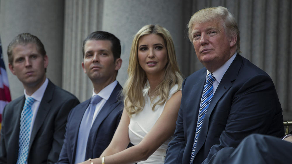 Former President Donald Trump (right) sits with his children (from left) Eric Trump, Donald Trump Jr., and Ivanka Trump. All four are named in a civil lawsuit filed Wednesday by New York Democratic Attorney General Letitia James.