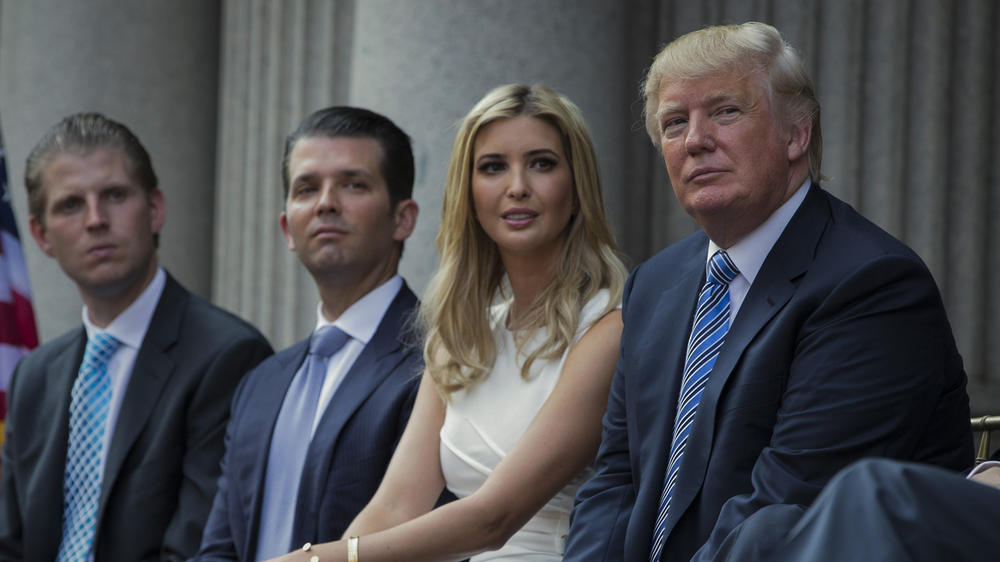 Former President Donald Trump (right) sits with his children (from left) Eric Trump, Donald Trump Jr., and Ivanka Trump. All four are named in a civil lawsuit filed Wednesday by New York Democratic Attorney General Letitia James.
