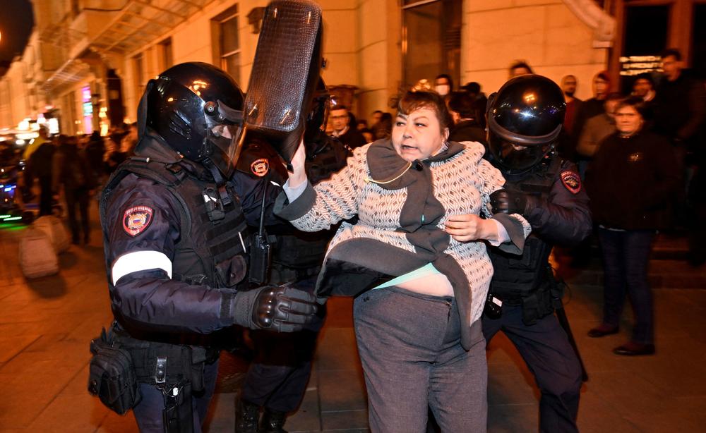 Moscow police officers detain a woman on Wednesday at a protest against the mobilization of up to 300,000 reserve troops to fight in Ukraine. Hundreds of protesters were arrested nationwide.