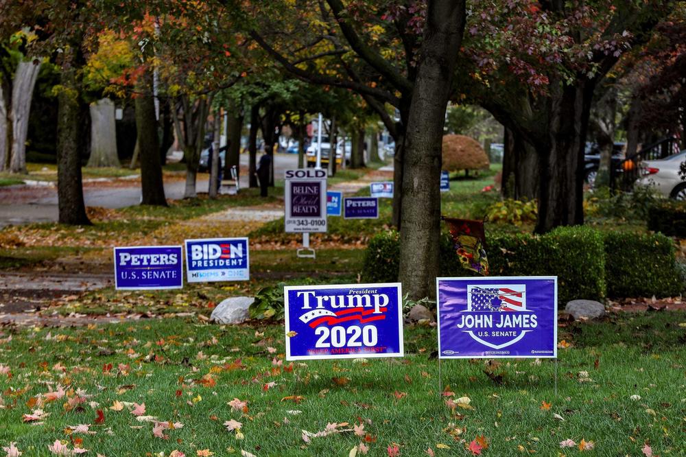 Neighbors display political yard signs in front of their homes in Grosse Pointe, Mich., in October 2020.