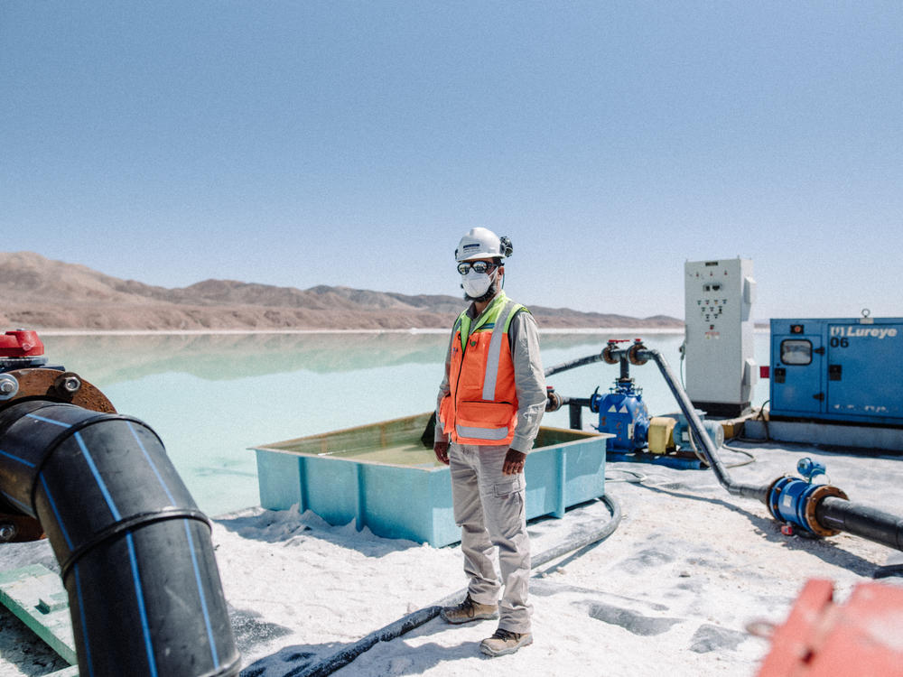 A worker performs maintenance on pipes used during brine extraction at a lithium mine in the Atacama Desert in Chile on Aug. 24.