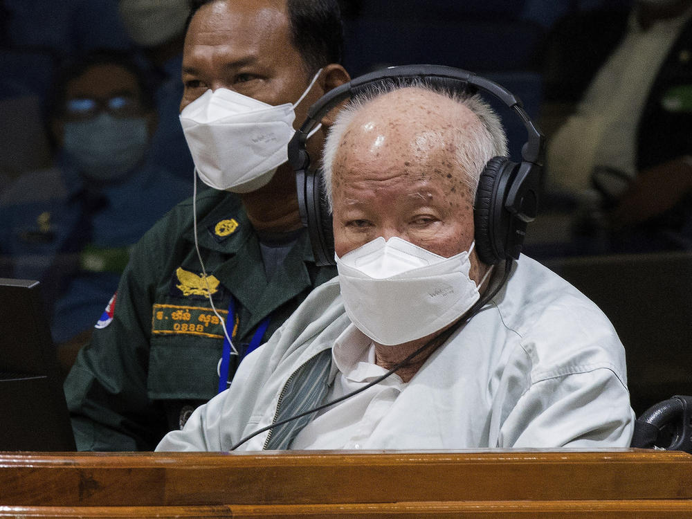 Khieu Samphan, right, the former head of state for the Khmer Rouge, sits in a courtroom during a hearing at the U.N.-backed war crimes tribunal in Phnom Penh, Cambodia, Thursday, Sept. 22, 2022.
