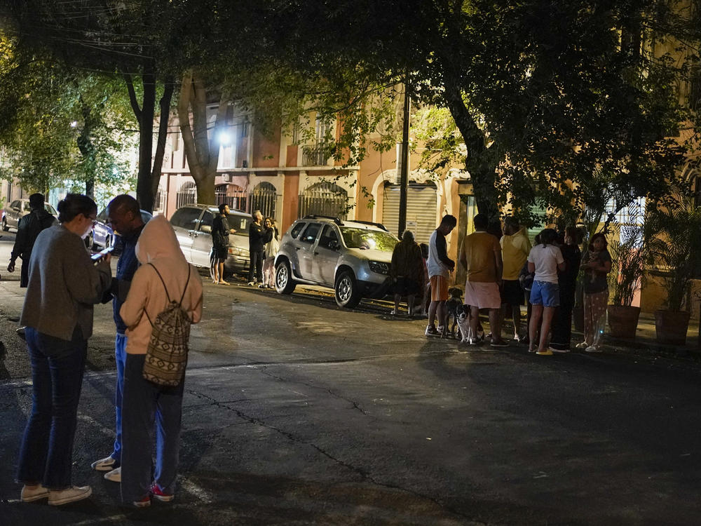 People gather outside after an earthquake was felt in Mexico City, Thursday, Sept. 22, 2022.
