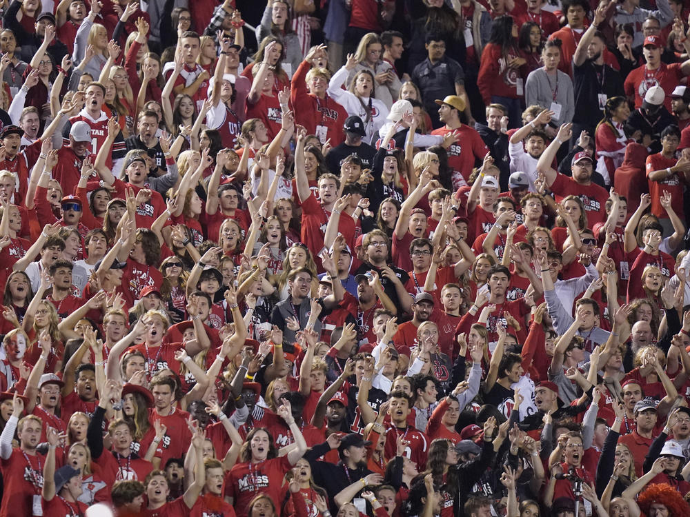 The Utah student section show their support during the first half of an NCAA college football game against San Diego State and Utah on Sept. 17, in Salt Lake City. A University of Utah student was arrested on suspicion of making terrorist threats after police said she threatened to detonate a nuclear reactor if the school's football team failed to win the game against San Diego.