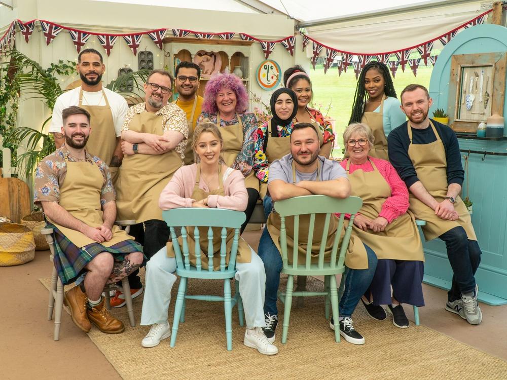 Group photo of Bakers in the Tent (L to R) (back) Sandro, William, Abdul, Carol, Maisam, Syabira, Maxy (front) James Rebs Janusz, Dawn, Kevin on <em>The Great British Baking Show</em> on Netflix<em>.</em>