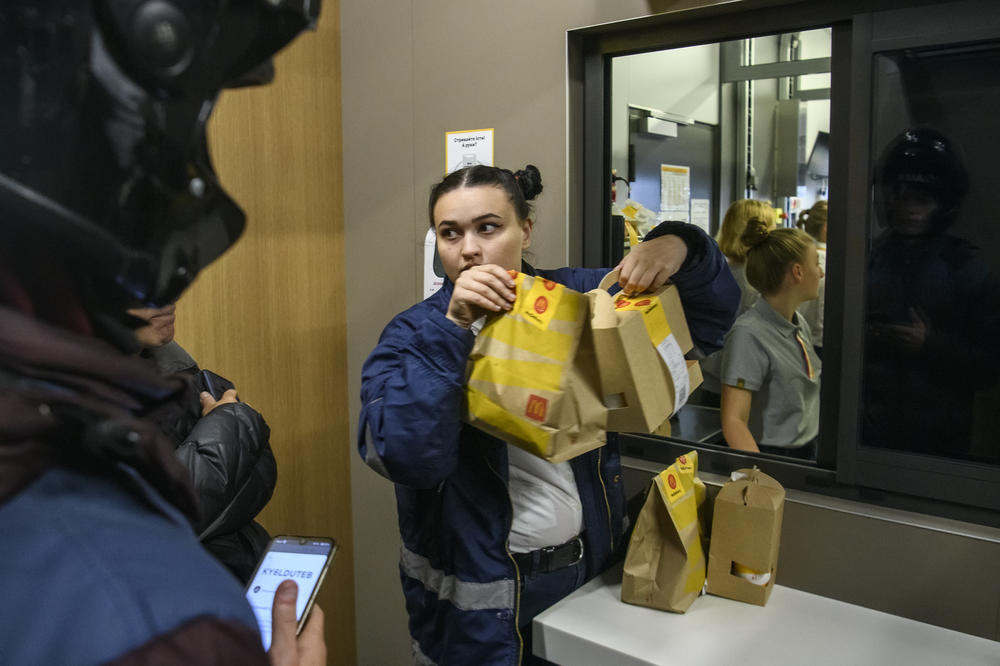 Customers and delivery couriers line up at a newly reopened McDonald's in Kyiv on Tuesday. Three locations in Kyiv reopened for the first time since Russia's invasion on Feb. 24.